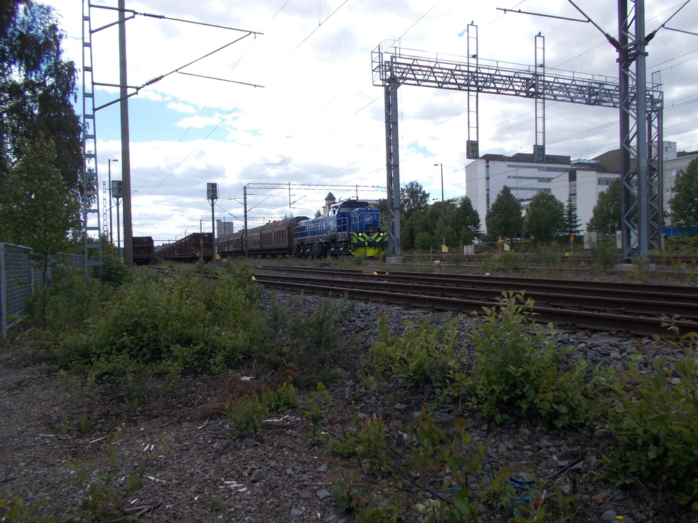 Fenniarailin tavarajuna 7001 Mikkelissä 13.6.2016
Fenniarail on saanut ensimmäisen veturinsa sekä ensimmäiset vuokravaununsa ja aloittanut koeajot Itä-Suomessa. Kaupallinen tavaraliikenne alkoi reilua kuukautta myöhemmin.
Avainsanat: op_Fenniarail;jt_Tavarajuna;jyv_Dr18;jyv_Laaiis;jyv_Fakks