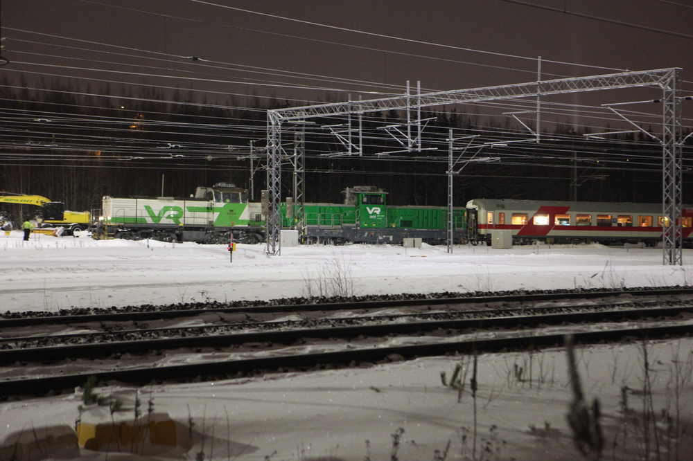 Ensimmäinen Dr19 saapuu Tampereelle 2.2.2022
Kakkospainotteisesta päivämäärästä 2.2.22 lukuunottamatta veturi oli numero 1, tai no, 2831, mutta sarjansa ensimmäinen kumminkin. Tilanteesta voisi löytää jopa jotain runollista, kun Dv12 2639 kiskoo tulevaa korvaajaansa sen ensimmäisellä matkalla maamme rataverkolla.
Avainsanat: op_VR;jt_Matkustajajuna_Virkatarve;jyv_Dv12;jyv_Dr19;jyv_Rk