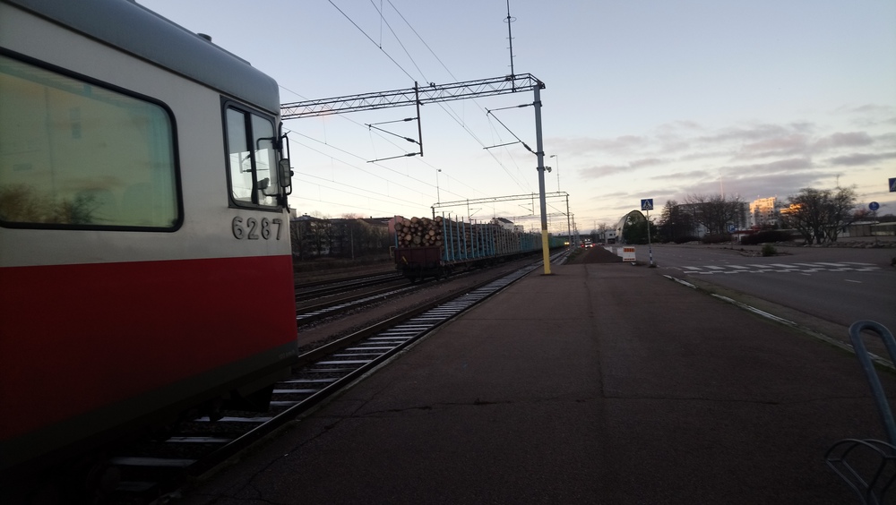 Kotkan sataman aamua 22.11.2018
Taajamajuna odottaa lähtöaikaansa kohti Kouvolaa Kotkan satamassa. Taustalla näkyy 14 raakapuuvaunua odottamassa pääsyä Kotkamillsille, jonka pihassa niitä on jo purettavana 10 vaunun verran. Taustalla erottuu myös päivystyshommissa ollut Dv12 2508.
Avainsanat: op_VR;jyv_Sm2;jyv_Sp
